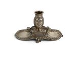 a silver candle holder with two candles on it
