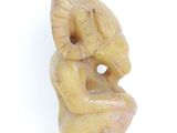 an image of a statue of a woman sitting on a chair