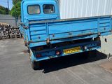 a blue truck that is parked in front of a building