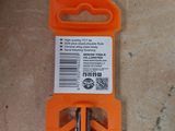 an orange key with a tag on it sitting on the floor