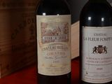 two bottles of wine sitting next to each other on a table