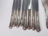 six forks and a knife on the table