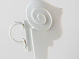 a white vase that has a spiral design on it