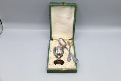 a silver spoon and fork in a green box