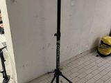 a tripod in the corner of a room with a camera on a tripod
