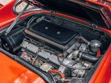 a red car with an engine in it ' s trunk