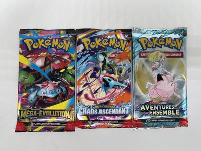 three packs of pokemon trading cards sitting on top of each other