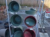 un support sur lequel sont disposées des casseroles et des poêles de différentes couleurs