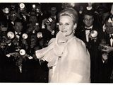 black and white photograph of a woman in front of a crowd of people