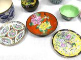 many plates and bowls sitting on a table together