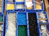 many plastic containers filled with different types of beads