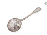 une cuillère ancienne en argent avec un motif floral sur le manche
