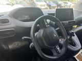the interior of a car with a steering wheel, dashboard, and dashboard controls