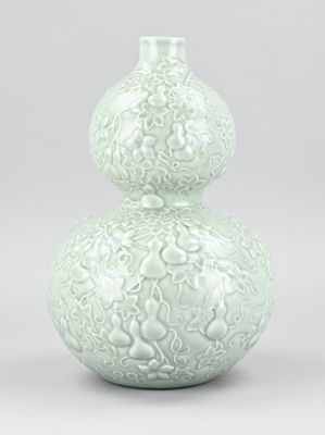 a white vase with a decorative design on it