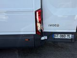 a white van parked in a parking lot with its door open