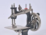a black and silver sewing machine on a white surface