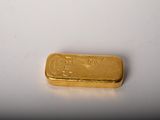 an image of a gold bar on a white surface