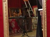 a mirror that is sitting on the floor in front of a red wall