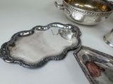 three silver dishes on a table next to each other
