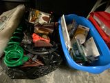 a blue plastic container filled with assorted items on the floor