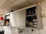 a kitchen with a stainless steel cabinet above the sink
