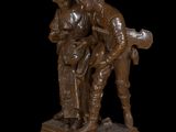 statue of a man and a woman with a guitar on a black background
