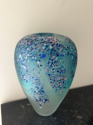 a glass vase that is sitting on top of a table