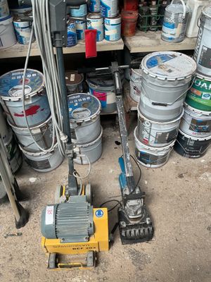 a small machine that is sitting next to a bunch of kegs