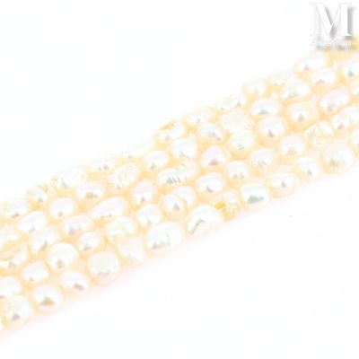 a close up of a row of white pearls on a white surface