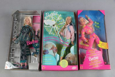 three barbie dolls are sitting in a box on a table