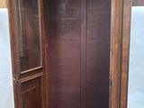 a wooden cabinet with a door open on the floor