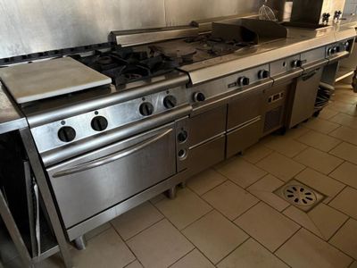 a kitchen with a stove, oven, and sink in it