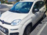 a small white car parked on the side of the road