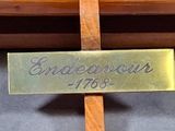 a wooden cross with a gold plaque on it