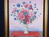 a painting of flowers in a vase on a easel