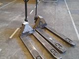 a fork lifter sitting on the floor in a warehouse