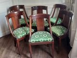 four chairs that are sitting in the corner of a room