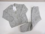 the sweater and pants are laid out on a white surface