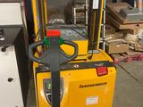 the forklift is parked in the warehouse with the back end of the fork lift
