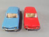 two toy cars sitting next to each other on a table