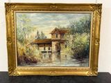 an oil painting of a house by a river in a gold frame