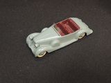 a toy car that is sitting on a black surface