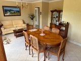 a dining room table with chairs and a couch in it