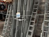 many ladders that are stacked up in a warehouse