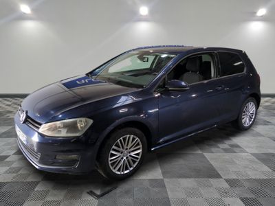 the blue volkswagen golf is parked on a checkered tile floor