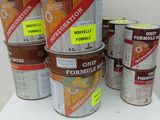 several buckets of paint sitting on top of a table next to each other