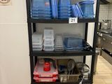 a black shelf with plastic containers on it in a kitchen