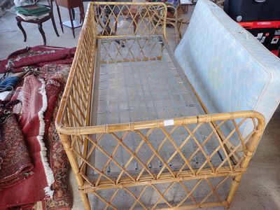 a bed that is made out of bamboo and has a metal frame