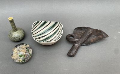 a small bowl, a vase, and a spoon on a table