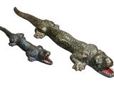pair of metal alligator figurines on a white background